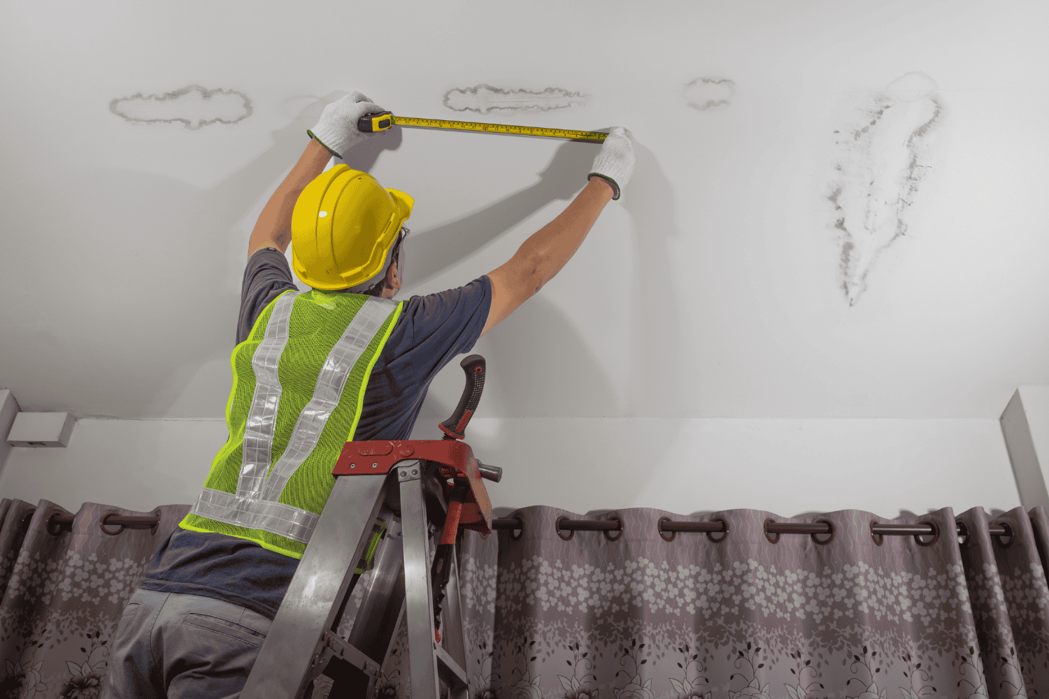 A professional roofing contractor assessing a roof for leaks.