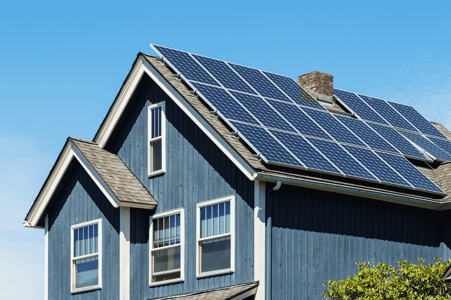 A residential solar installer working on a solar panel installation.